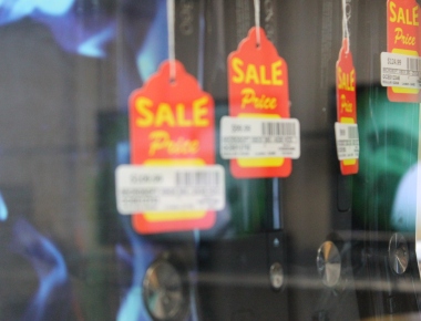 sale tags hanging in pawn shop window