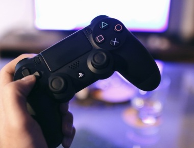hand holding a playstation controller